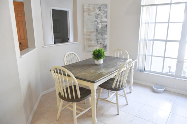 dining space featuring light tile patterned flooring