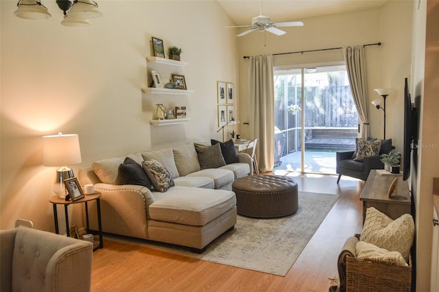 living room with lofted ceiling, light hardwood / wood-style floors, and ceiling fan