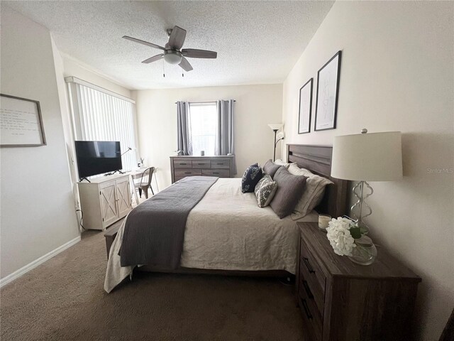 bedroom featuring dark colored carpet, ceiling fan, and a textured ceiling