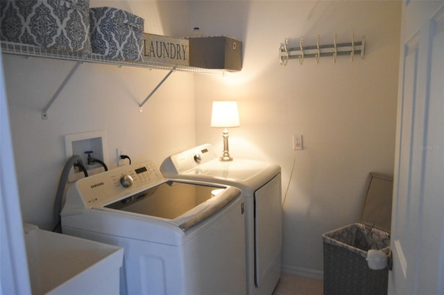 laundry room with separate washer and dryer and sink