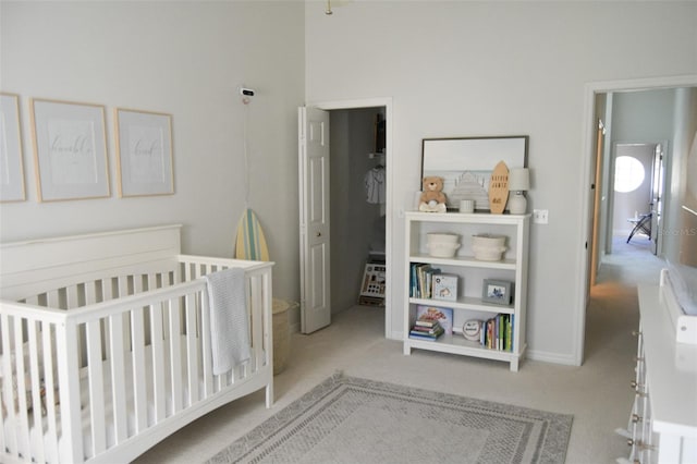 carpeted bedroom with a nursery area