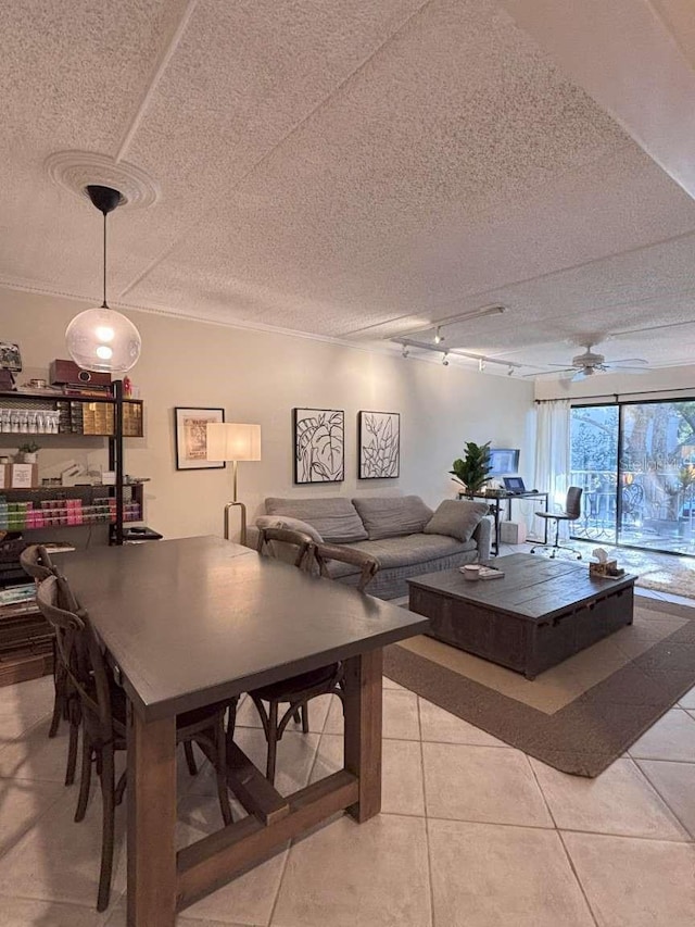 living room with ceiling fan, light tile patterned flooring, a textured ceiling, ornamental molding, and rail lighting