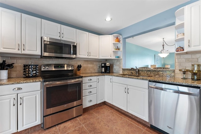 kitchen with sink, stainless steel appliances, white cabinetry, and tasteful backsplash