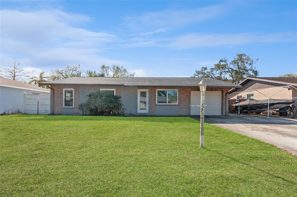 ranch-style house with a front yard and a garage