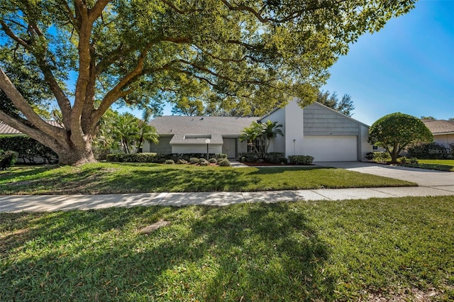 ranch-style home featuring a garage and a front yard