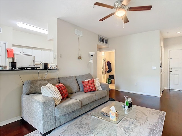 living room featuring hardwood / wood-style floors and ceiling fan