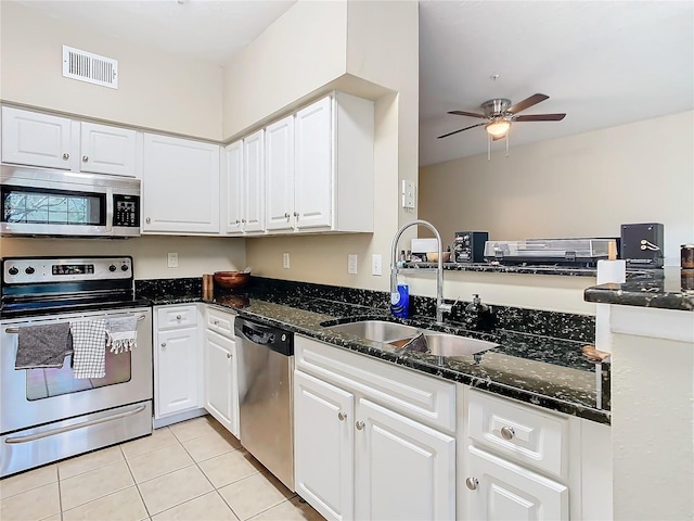 kitchen featuring sink, white cabinetry, appliances with stainless steel finishes, and light tile patterned flooring