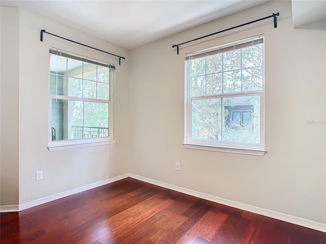 unfurnished room with wood-type flooring