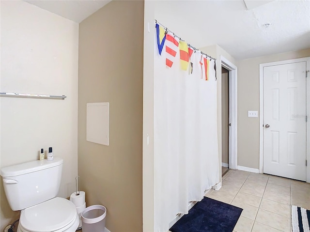 bathroom with toilet and tile patterned flooring