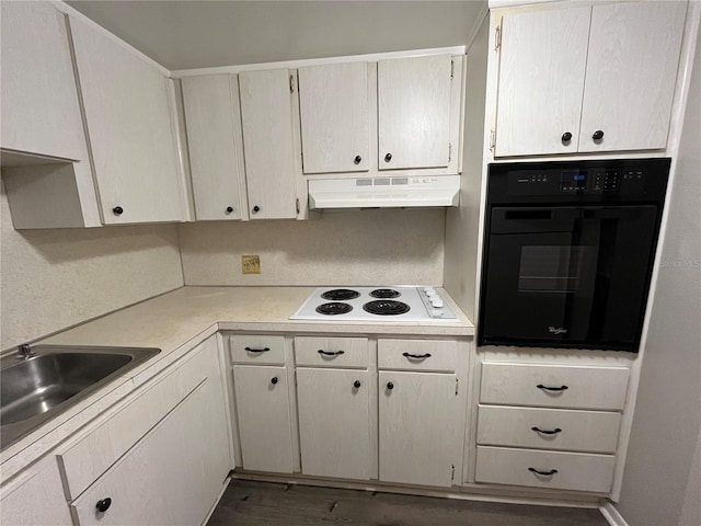 kitchen featuring sink, white electric stovetop, dark hardwood / wood-style flooring, and black oven