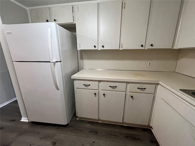 kitchen featuring white refrigerator and dark hardwood / wood-style flooring