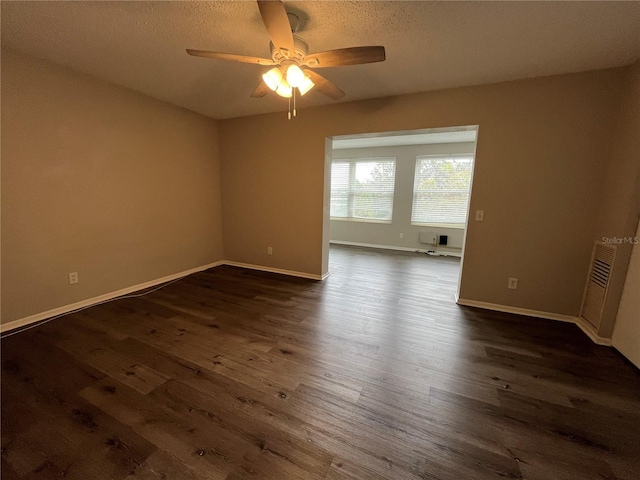 unfurnished room with ceiling fan and dark wood-type flooring