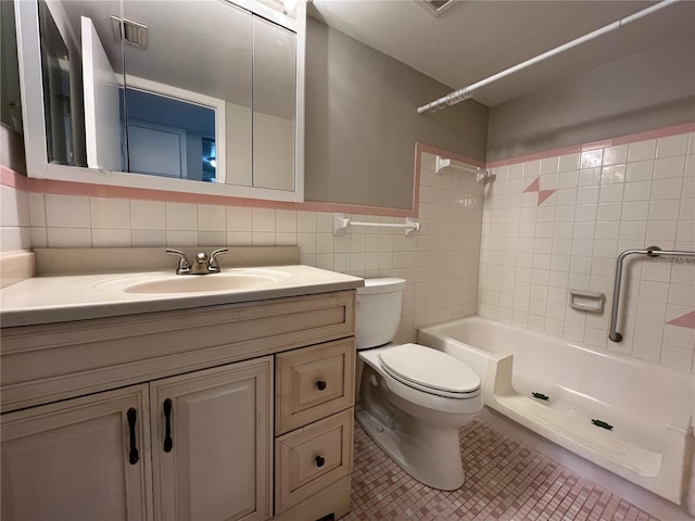 full bathroom with toilet, tasteful backsplash, tile walls, vanity, and tiled shower / bath