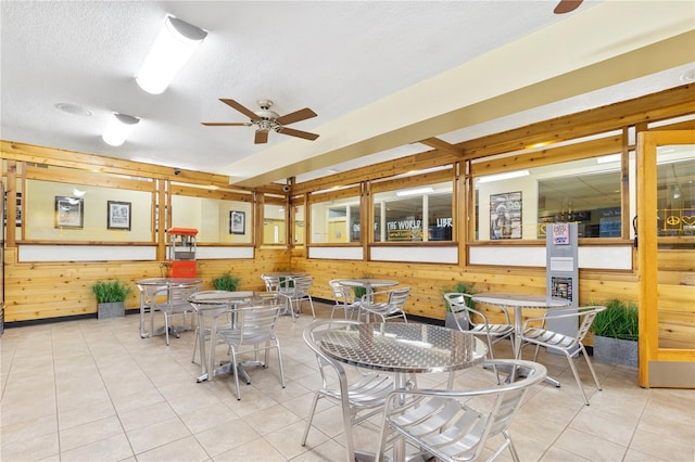 interior space with ceiling fan