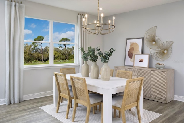 dining area with hardwood / wood-style flooring and an inviting chandelier