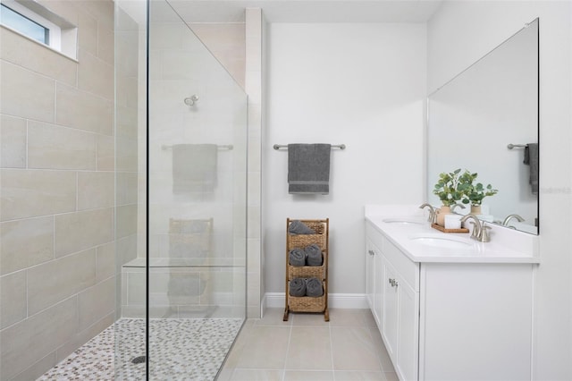 bathroom with vanity, a tile shower, and tile patterned flooring