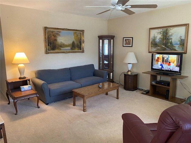 carpeted living room with ceiling fan