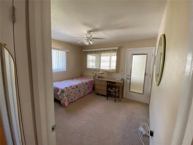 bedroom with ceiling fan, light colored carpet, and refrigerator