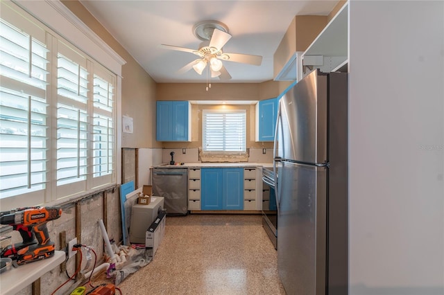 kitchen featuring blue cabinets, stainless steel appliances, a healthy amount of sunlight, and ceiling fan