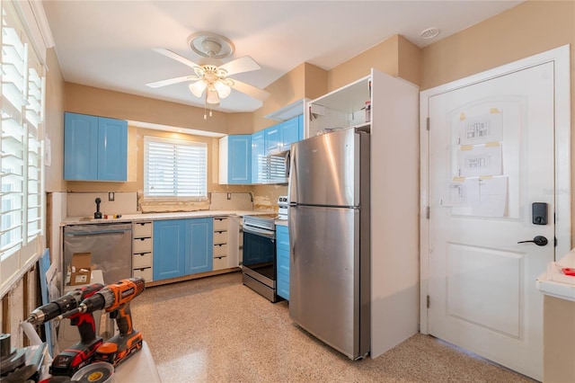 kitchen with blue cabinetry, ceiling fan, and stainless steel appliances