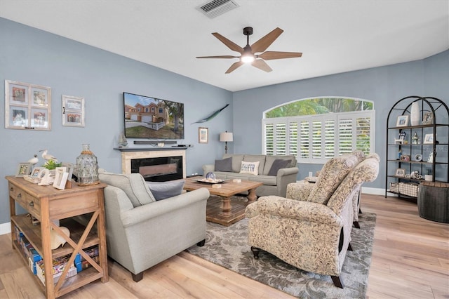 living room featuring ceiling fan and light wood-type flooring