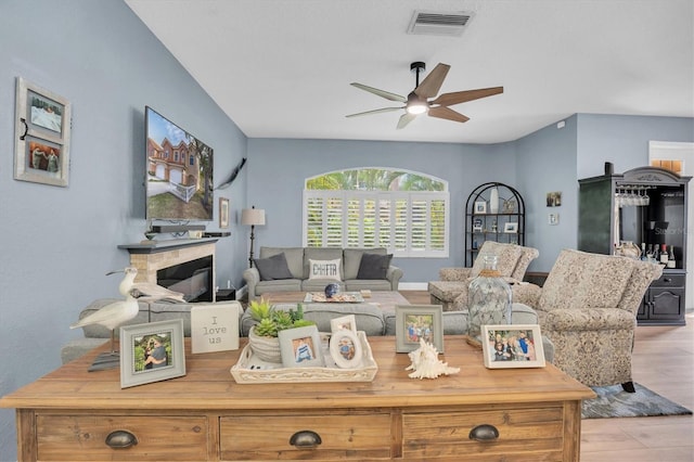 living room featuring ceiling fan and light hardwood / wood-style flooring