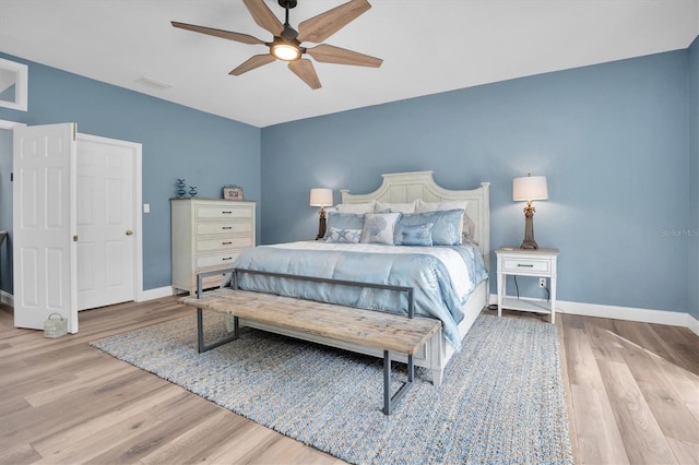 bedroom with ceiling fan and light hardwood / wood-style flooring