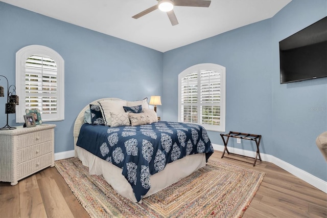 bedroom with ceiling fan and wood-type flooring