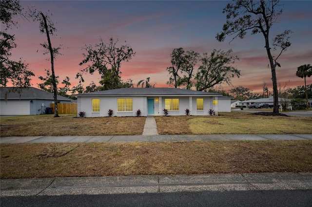 ranch-style house with a lawn