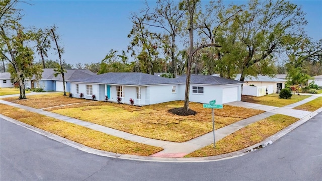 single story home featuring a front yard and a garage