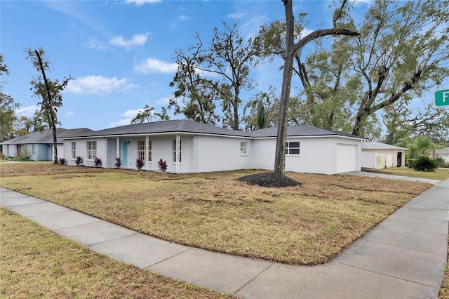 single story home with a garage and a front yard