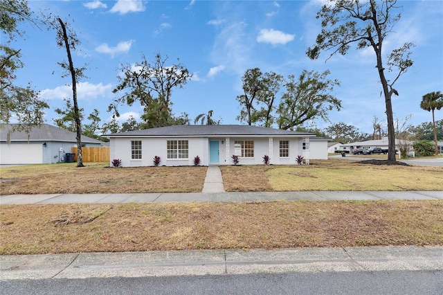 ranch-style home featuring a front yard