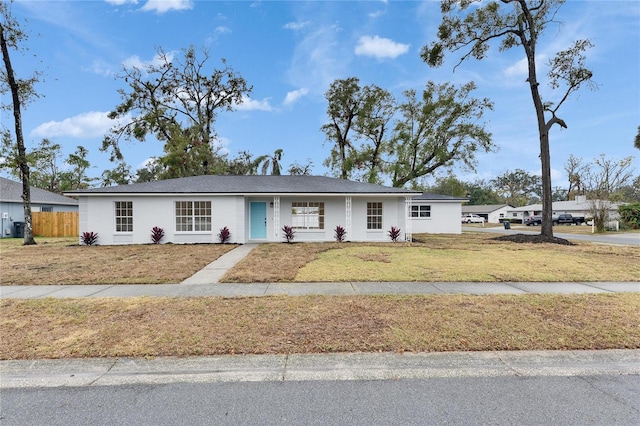 ranch-style house with a front lawn