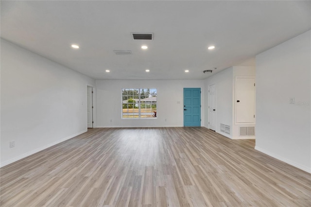 empty room with light hardwood / wood-style flooring