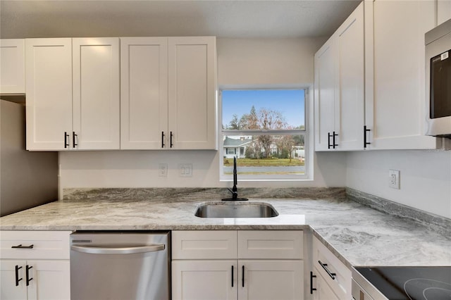 kitchen featuring white cabinets, appliances with stainless steel finishes, and sink