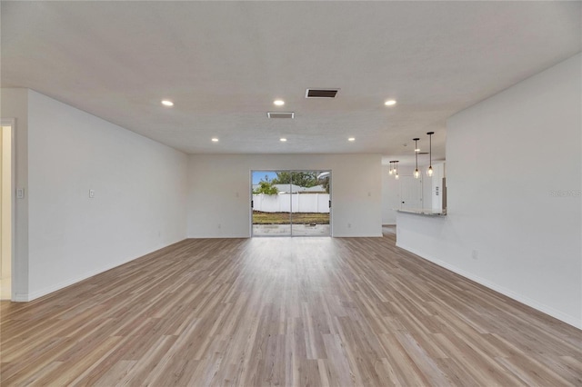 unfurnished living room with light hardwood / wood-style flooring