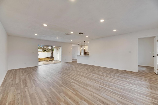 unfurnished living room with light wood-type flooring