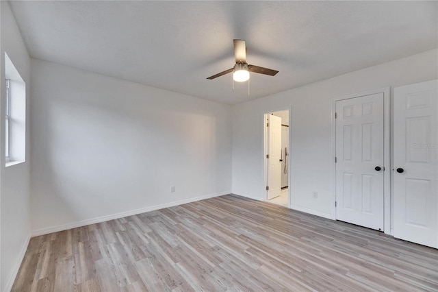 unfurnished bedroom with light hardwood / wood-style flooring, a closet, and ceiling fan