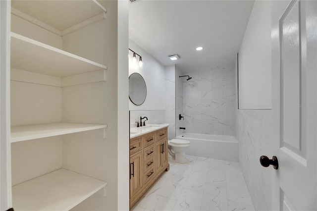 full bathroom featuring toilet, vanity, and tiled shower / bath