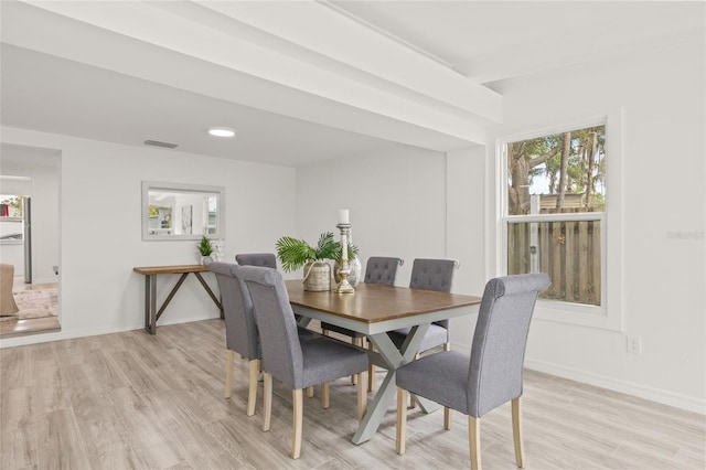 dining room featuring a wealth of natural light and light hardwood / wood-style floors