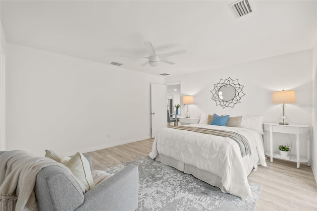 bedroom with ceiling fan and light hardwood / wood-style flooring