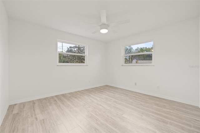 empty room with ceiling fan and light hardwood / wood-style flooring