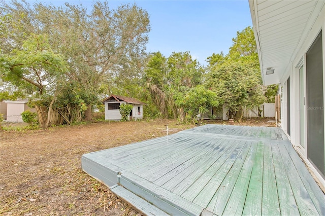 wooden terrace with a storage shed