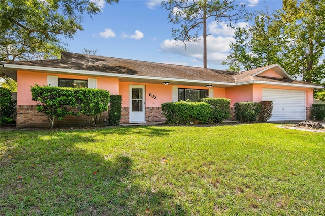 single story home with a garage and a front lawn