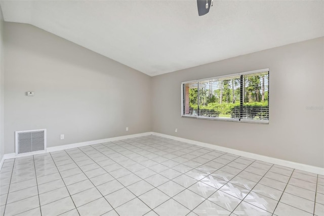 spare room featuring lofted ceiling