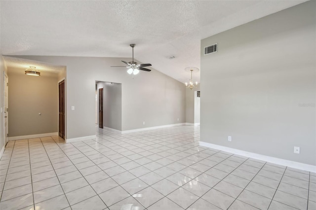 spare room with ceiling fan with notable chandelier, vaulted ceiling, a textured ceiling, and light tile patterned floors