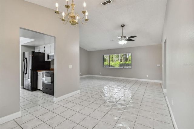 interior space featuring vaulted ceiling, ceiling fan with notable chandelier, and light tile patterned floors