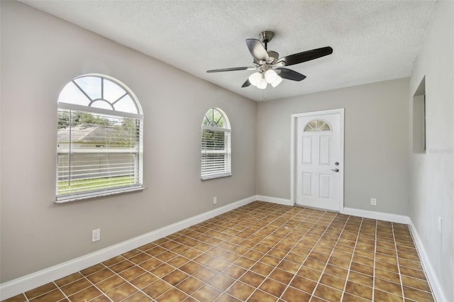 unfurnished room featuring a textured ceiling and ceiling fan