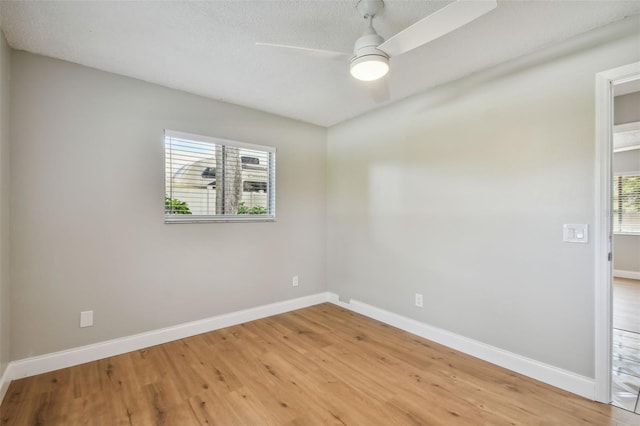 spare room featuring a textured ceiling, wood-type flooring, and ceiling fan