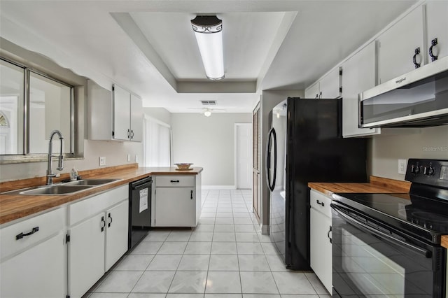 kitchen featuring sink, black appliances, white cabinets, and ceiling fan